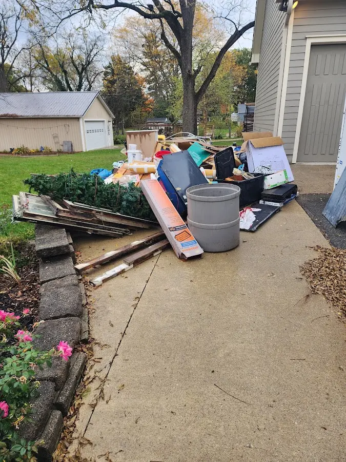 Dumpster being loaded with debris for Estate Cleanout Dumpster Rental in Sanbornton